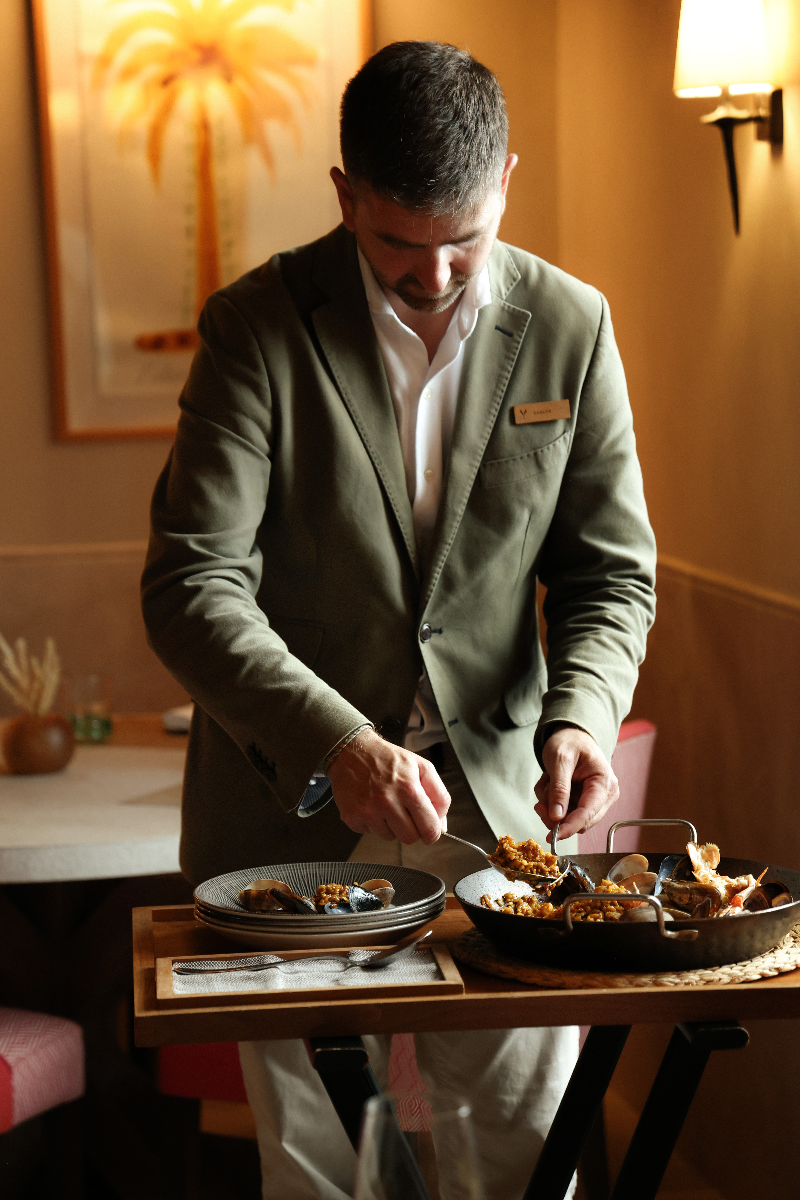 Waiter serves fresh paella